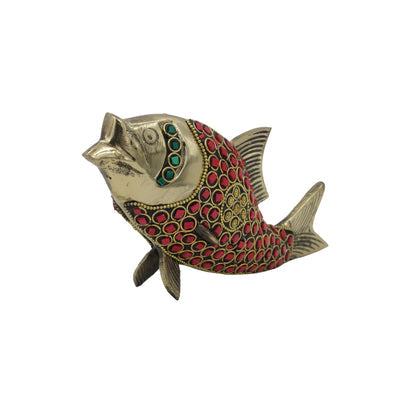 Decorative fish figurine with red and green accents on a white background