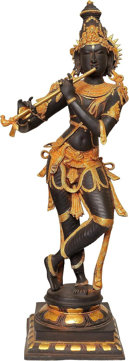 Monumental 36-inch solid brass Krishna idol in Tribhanga pose playing flute — dramatic black and gold two-tone finish with ornate gold jewellery, garland and crown on stepped base — ArtyCraftz