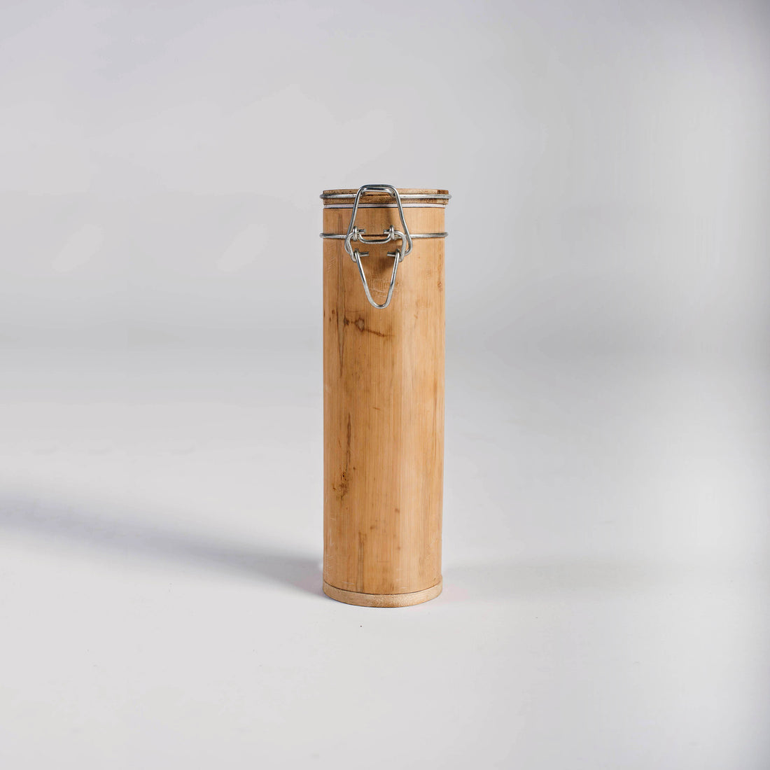 Cylindrical bamboo storage canister with metal clasp