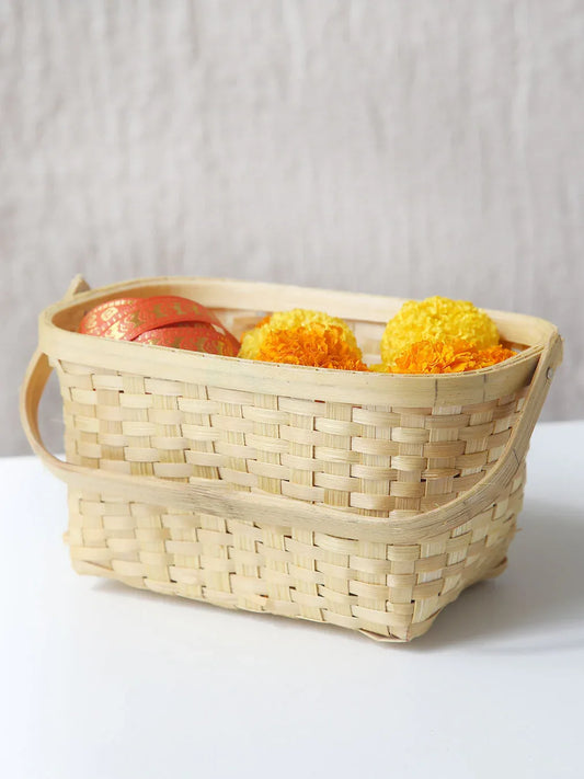 Woven basket with flowers on a white surface