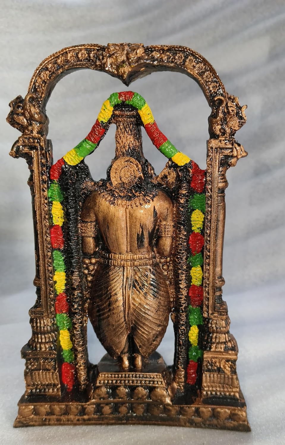 Handcrafted 21 cm polyresin Tirupati Balaji Venkateswara idol with decorative arch, temple pillars, colourful garlands and antique copper-black finish — ArtyCraftz