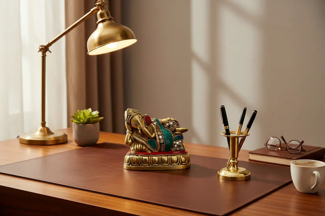 Handcrafted 4-inch solid brass reclining Ganesha idol with turquoise and coral stone inlay on garment and cushion, resting on lotus base — unique lazy Ganpati statue — ArtyCraftz