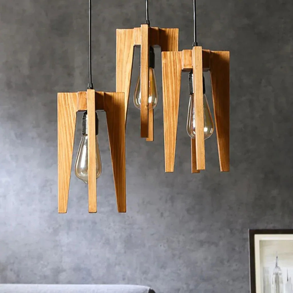 Wooden pendant light fixture with three hanging lights against a gray wall.
