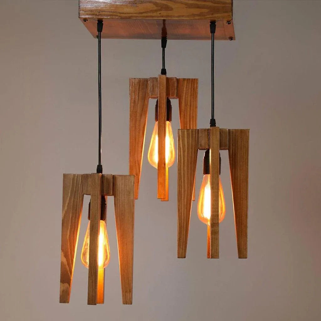 Wooden pendant light fixture with three lit bulbs on a plain background