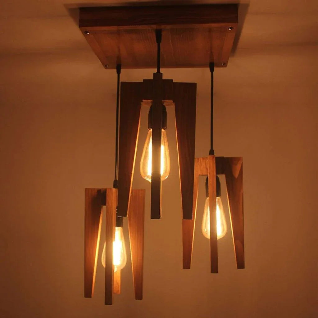 Wooden pendant light fixture with three lit bulbs against a warm background