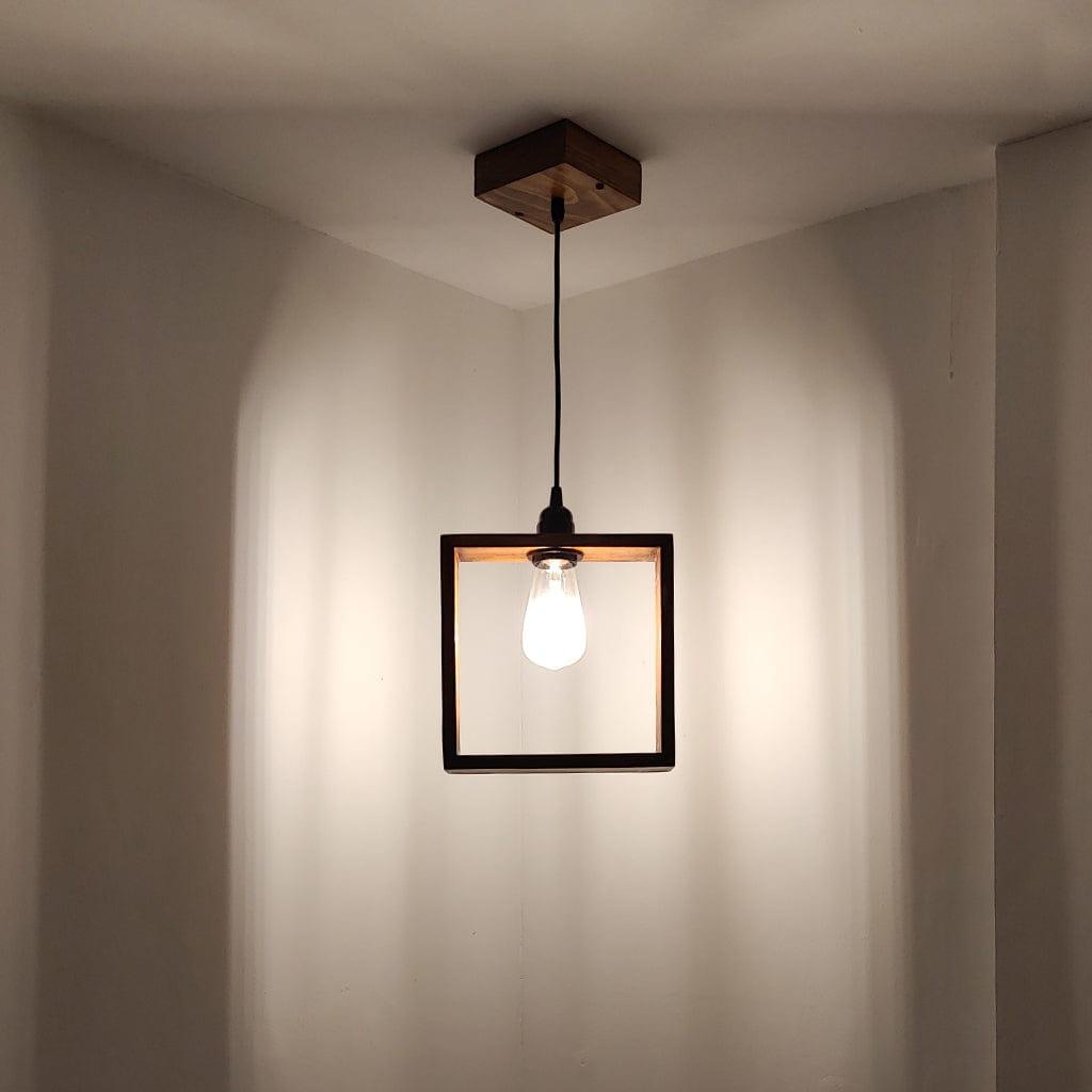 Square pendant light hanging from the ceiling in a neutral setting