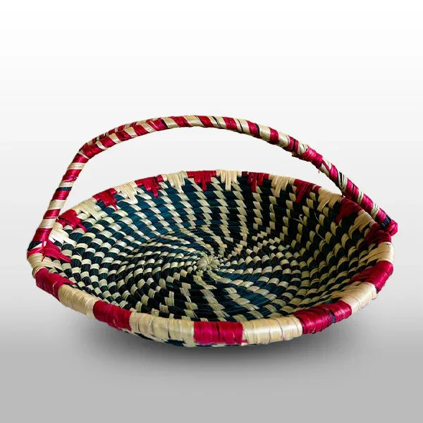 Woven basket with red, black, and beige pattern on a white background