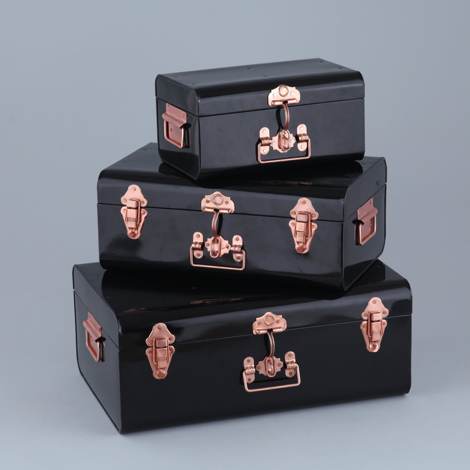 Set of three black boxes with rose gold accents