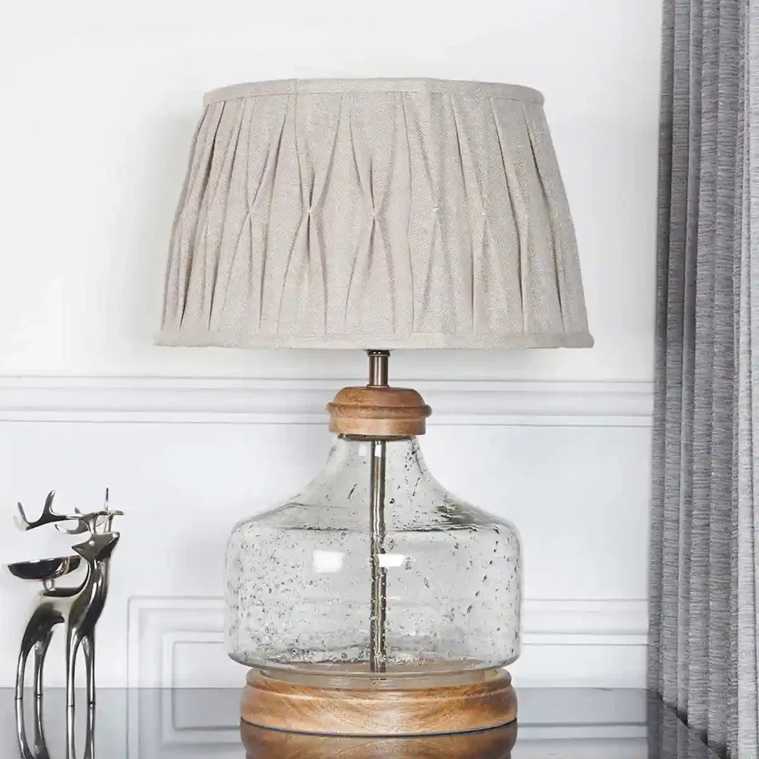 Tuscan Glass and Wood Table Lamp With Natural Linen Shade on Glass Table