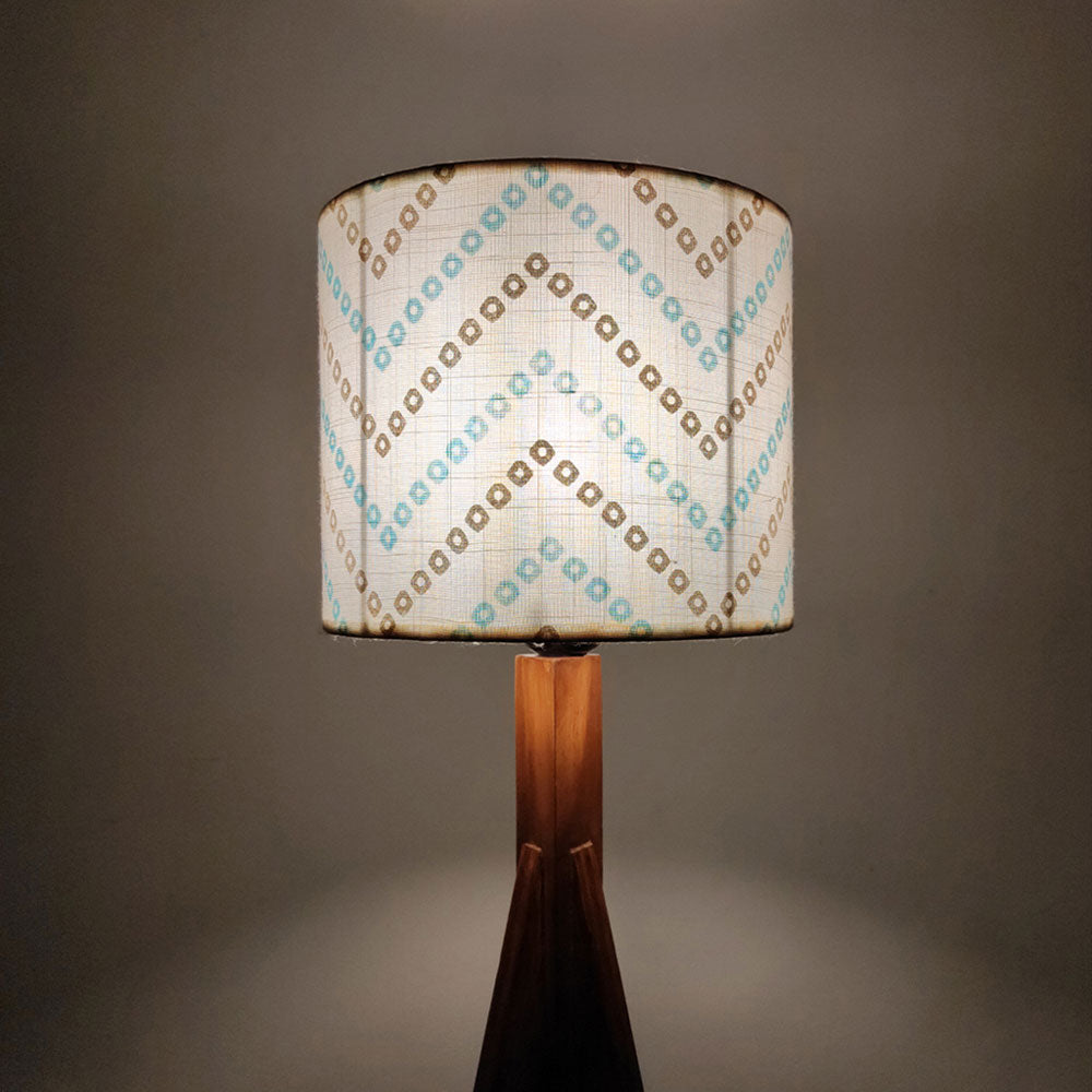 Lamp with a patterned shade on a dark background