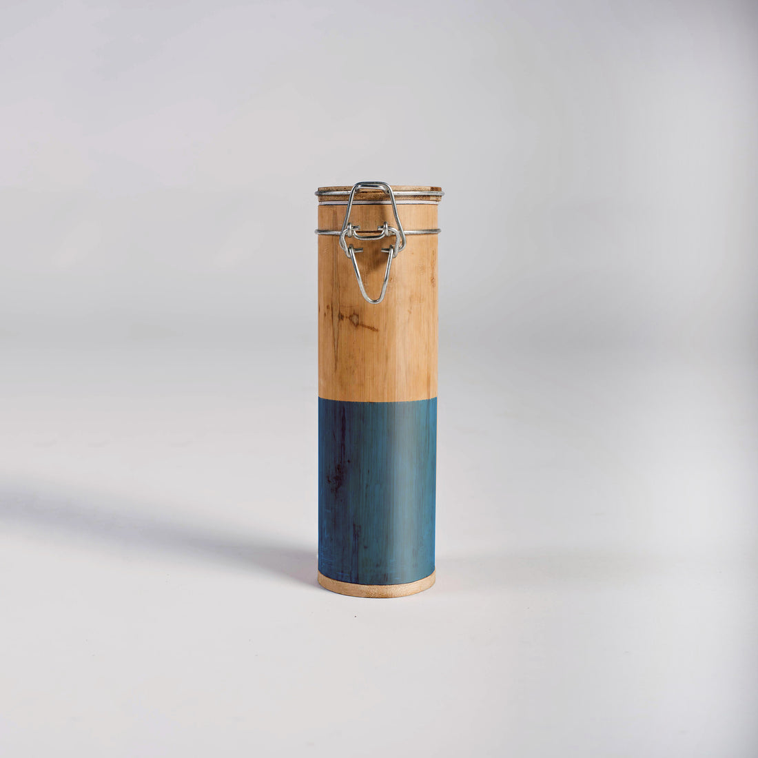 Two-toned cylindrical container with wooden top and blue bottom