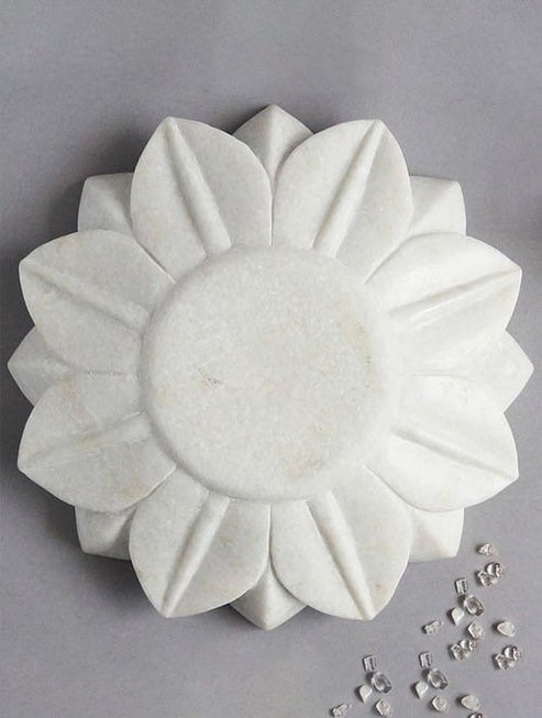 White marble flower-shaped bowl on a gray background