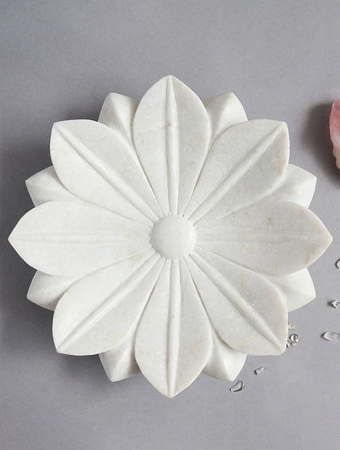 White floral-shaped soap on a gray background