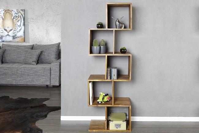 Wooden geometric shelf with decorative items against a gray wall
