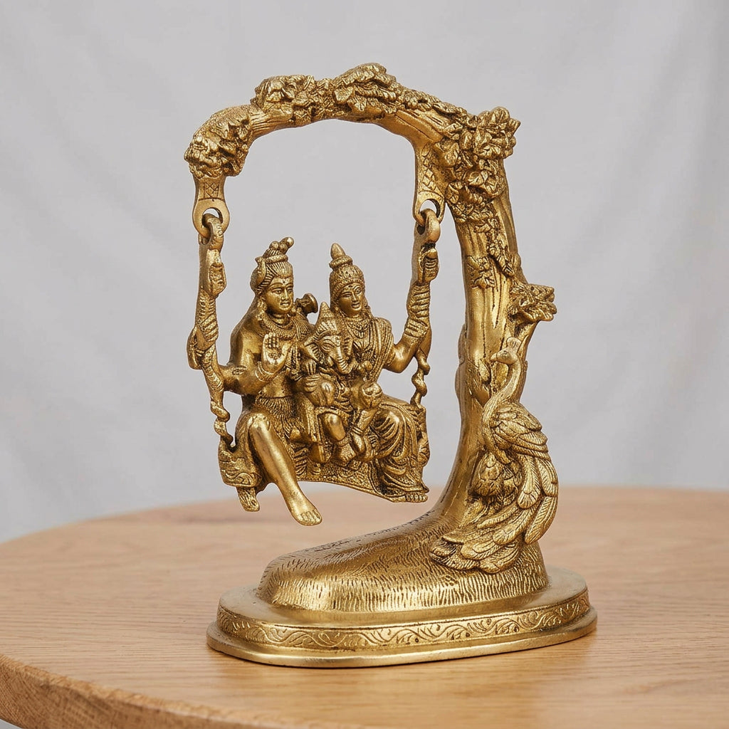 Golden brass statue of Shiva, Parvati and Ganesha seated on a decorative swing beneath an ornate arch-artycraftz.com