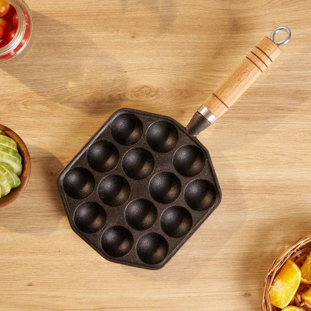 Cast iron pan with wooden handle on a wooden surface