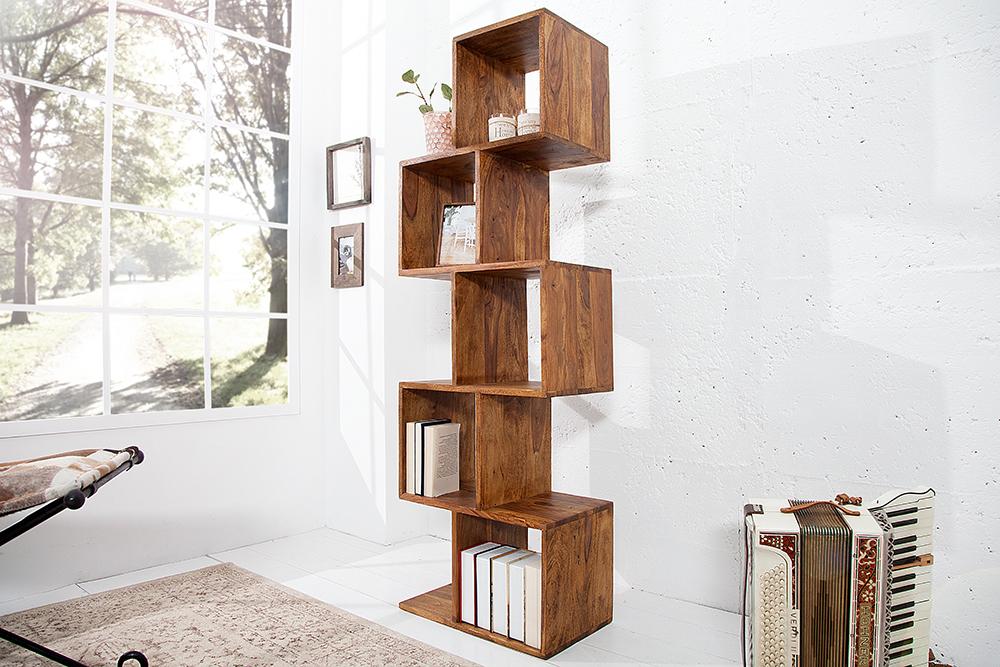 Wooden bookshelf with books against a white wall