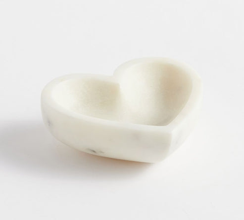 Heart-shaped white stone on a light gray background