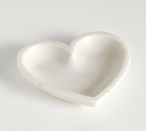 White heart-shaped object on a light gray background