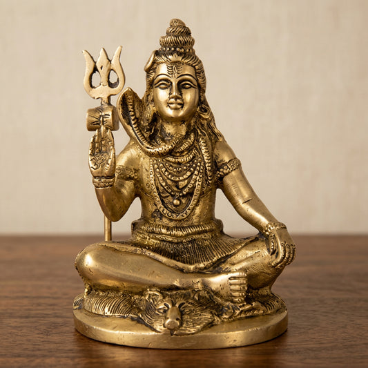 Golden-tone statue of Lord Shiva seated with a Trishul, cobra and detailed ornamental base-artycraftz.com
