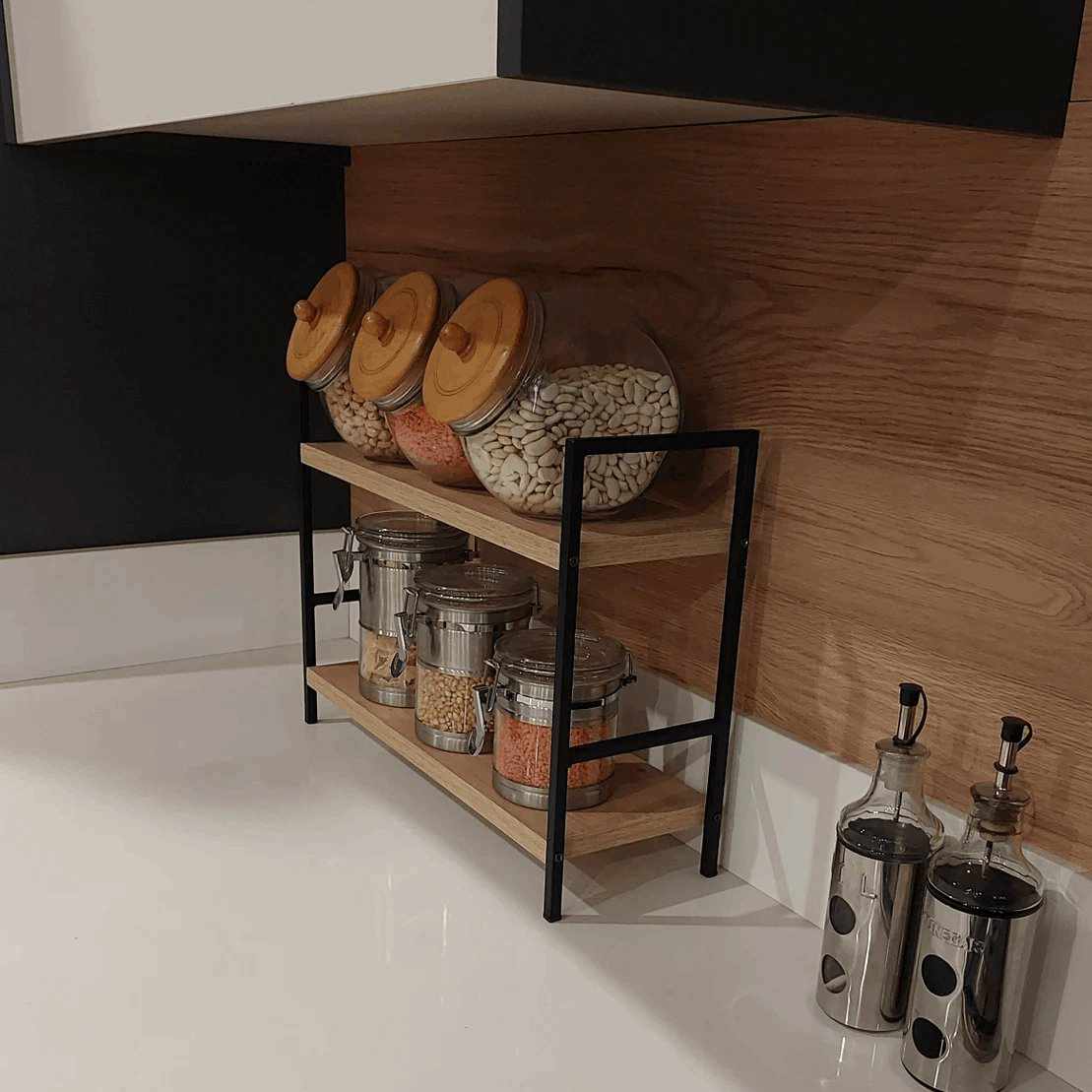 Spice rack with various jars on a kitchen shelf