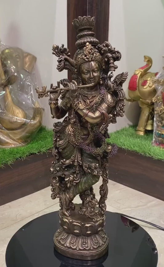 Handcrafted 35 cm multicolour resin Krishna idol in Tribhanga pose playing flute, ornate scrollwork body, green dhoti, gold jewellery finish, on decorative lotus base — ArtyCraftz